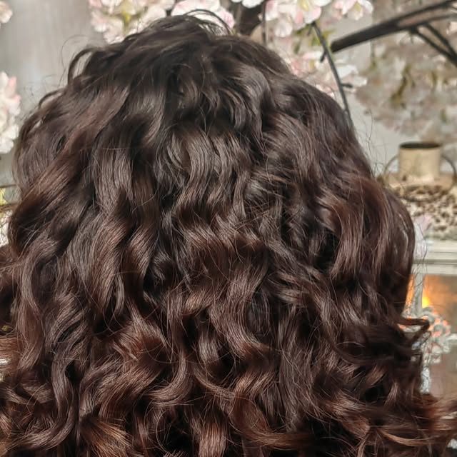 Dark brunette curls after a curly restyle and colour
